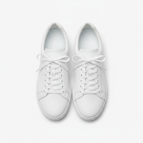 White minimalist daily sneakers with clean lines, beige suede accents, and a cushioned sole, displayed on a neutral background